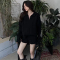 Women's creamy-white cable knit jumper and shorts set with an elasticated waistband.