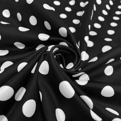 A women's polka dot pleated dress with a square collar and zip closure.