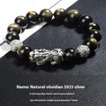 Men's geometric bracelet with obsidian stone set in 999 sterling silver on a wrist.