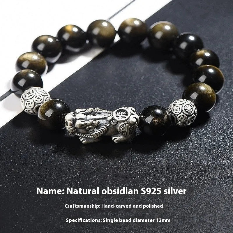 Men's geometric bracelet with obsidian stone set in 999 sterling silver on a wrist.