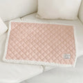 Quilted terry cloth cat blanket in blue, shown on a pet bed.