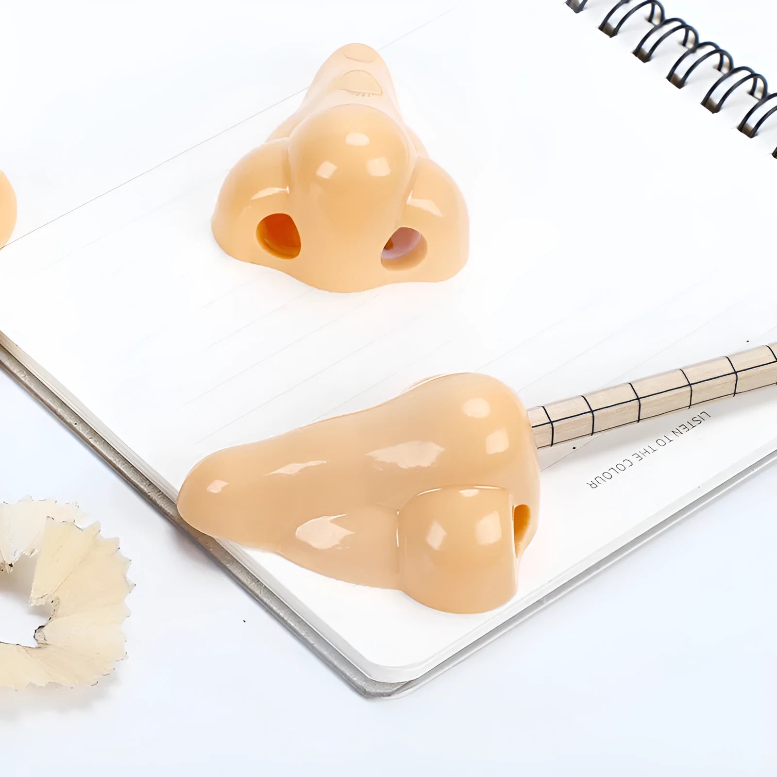 Geometry plastic pencil sharpener with big nostril opening in flesh colour measuring 58x45x30mm