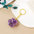 Small natural crystal cat's paw shaped keychain pendant on a keyring.