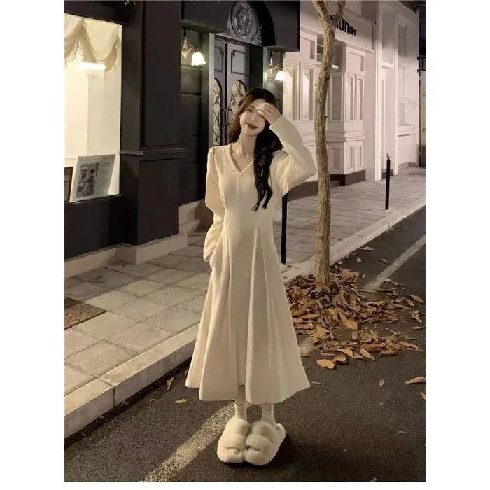 Women's long sleeveless V-neck knitted dress in milky white with a suspender skirt design.
