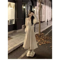 Women's long sleeveless V-neck knitted dress in milky white with a suspender skirt design.