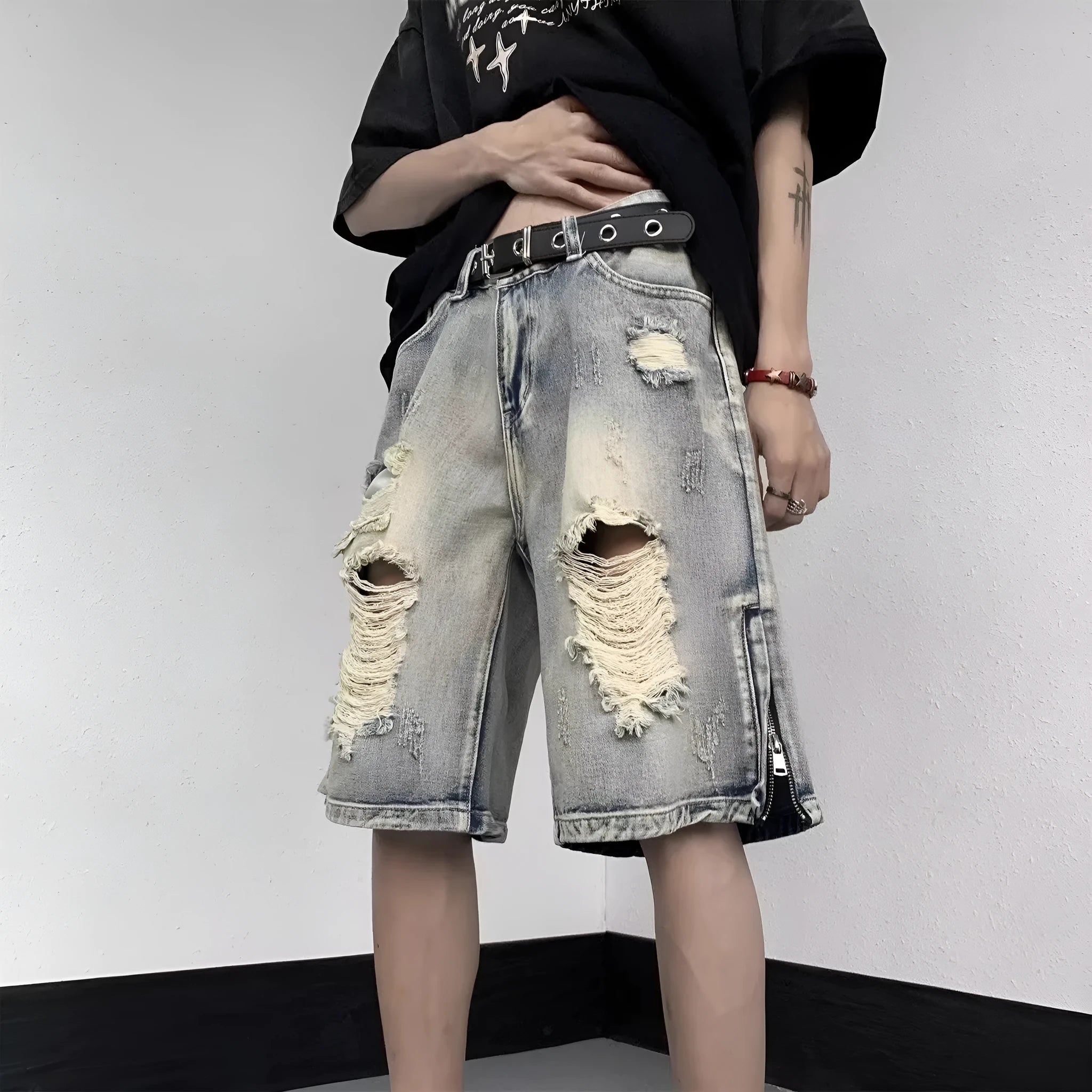 Blue retro tattered denim shorts with a wide leg loose fit on a person