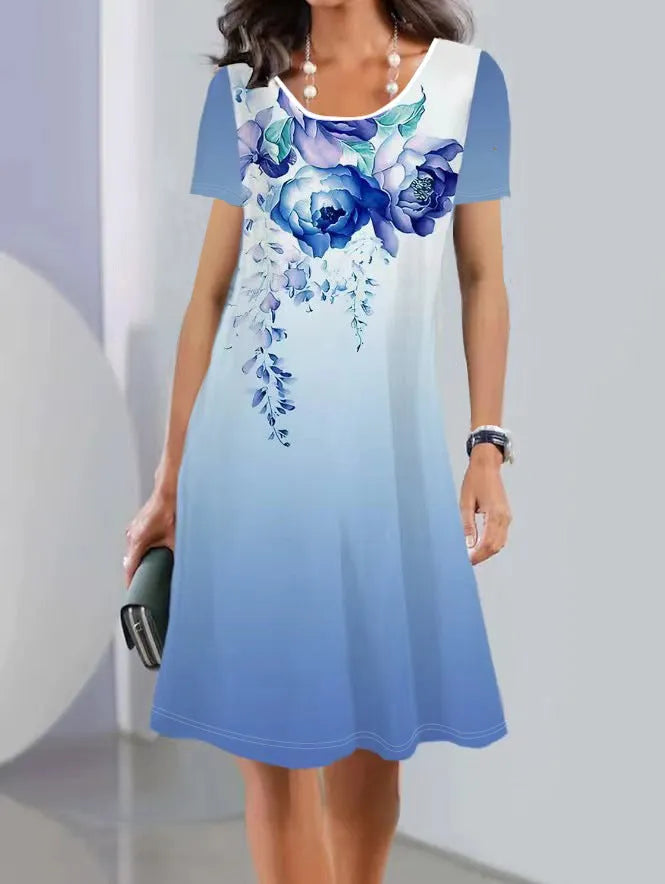 Women's mid-length summer dress with a floral print on light fabric, showing short sleeves and an A-line skirt.
