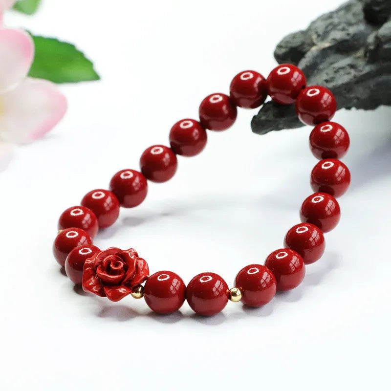 Close-up of a women's natural cinnabar bracelet with a detailed 8mm purple gold sand rose centrepiece.