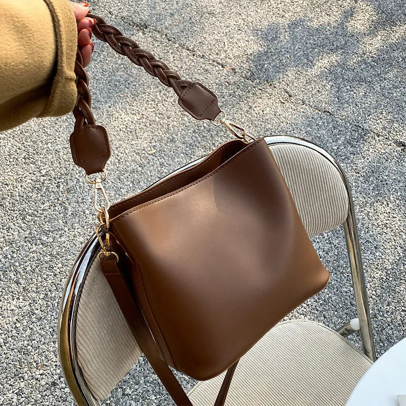 Retro style woven PU one-shoulder crossbody bucket bag in khaki colour.