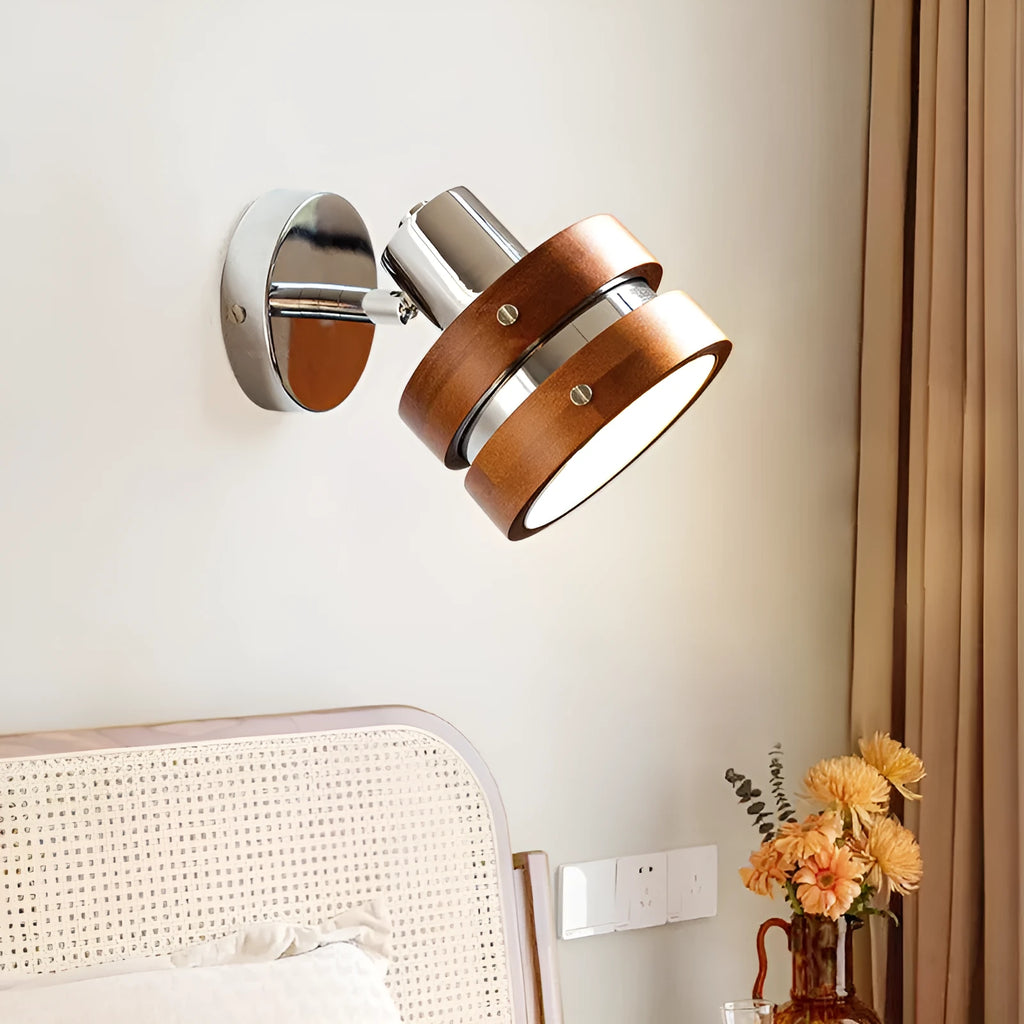 Small Scandinavian-style wall lamp with walnut wood finish, mounted on a wall.