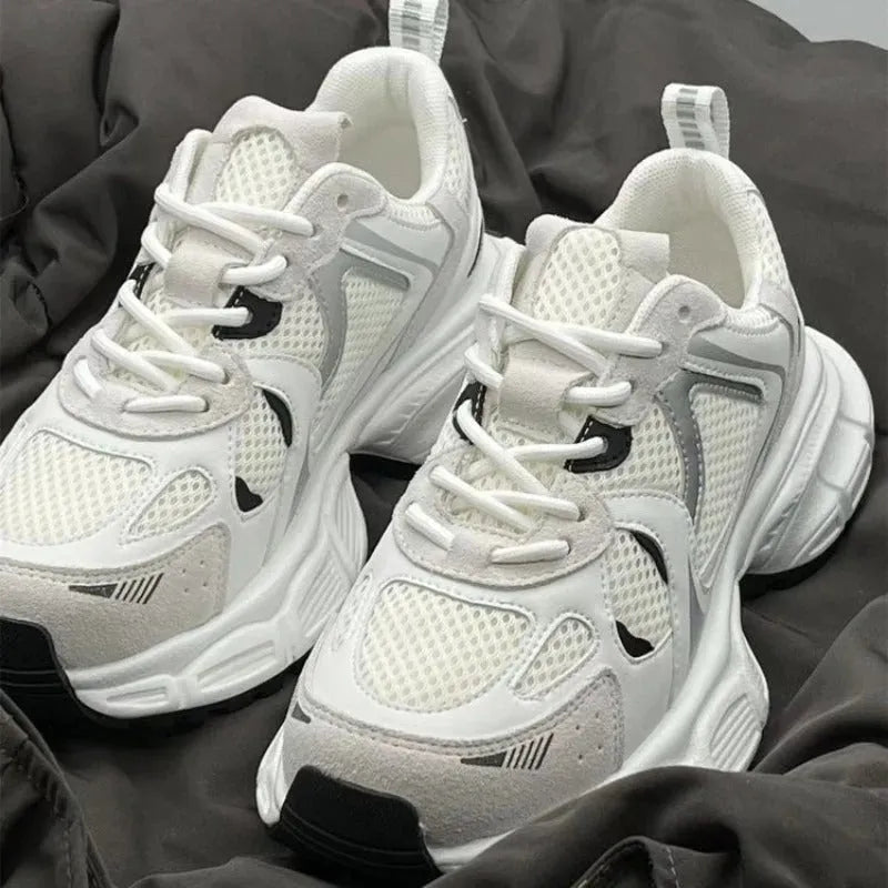 Beige mesh platform sports shoes with a wedge heel and front lace-up fastening.