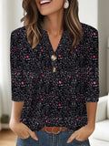 Woman wearing a loose-fit grey V-neck top with a colourful 3D geometric pattern print.