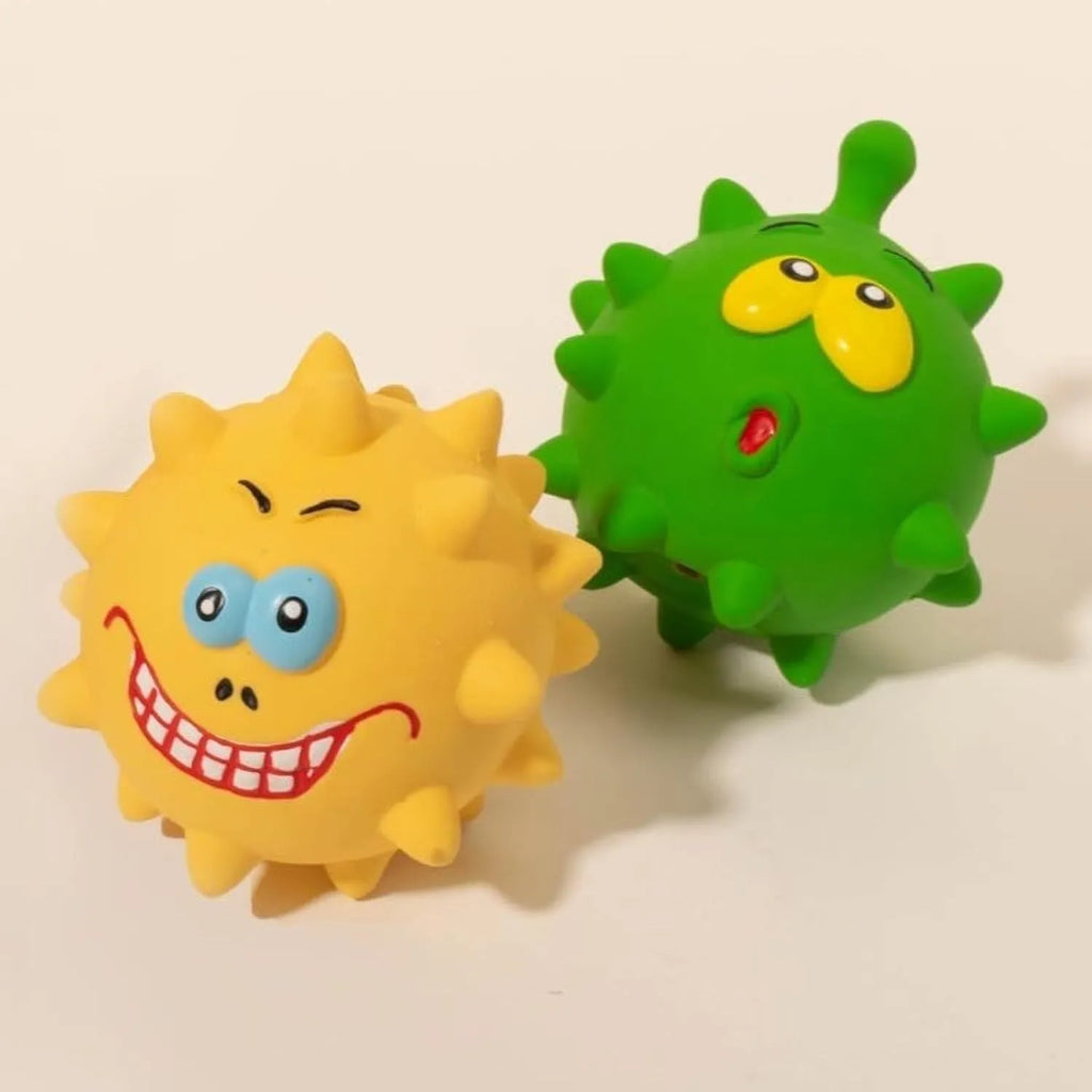 Four colourful squeaky dog balls with cute faces made from natural latex rubber