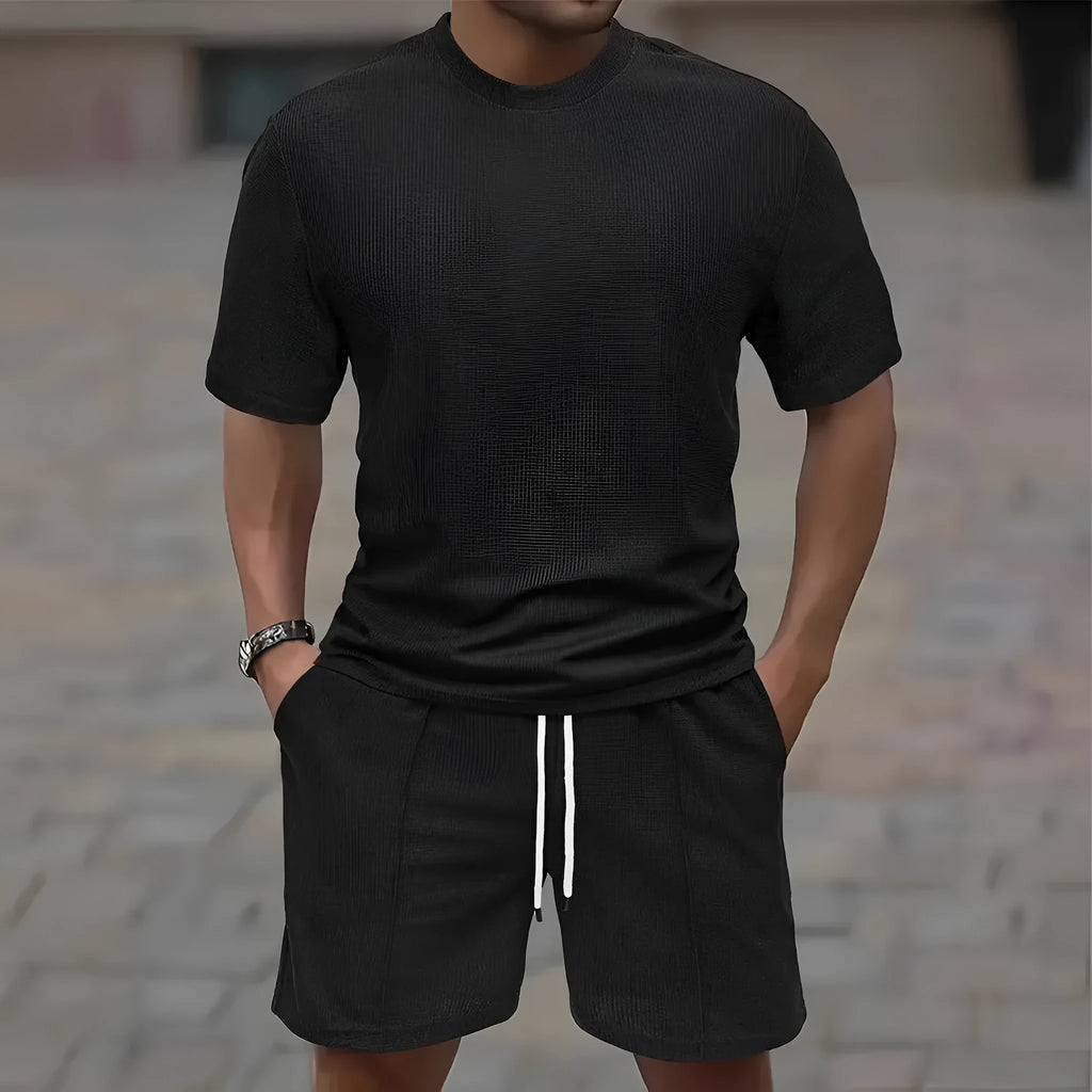 Man wearing a light waffle-texture short sleeve blouse and matching shorts in apricot colour.