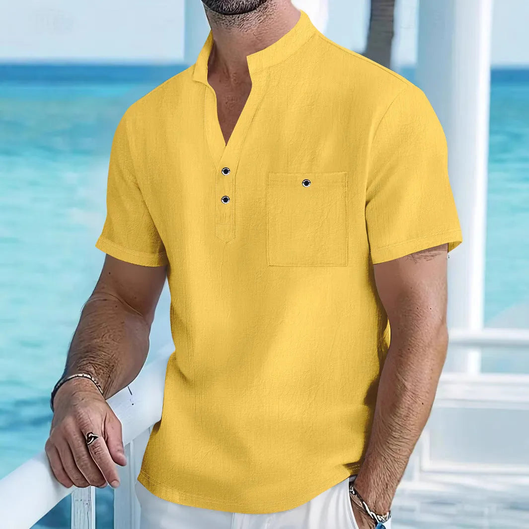 Man wearing a light apricot-coloured linen stand collar short sleeve shirt with a loose fit.