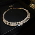 Round curved geometric alloy necklace in silver colour, designed as a clavicle chain.