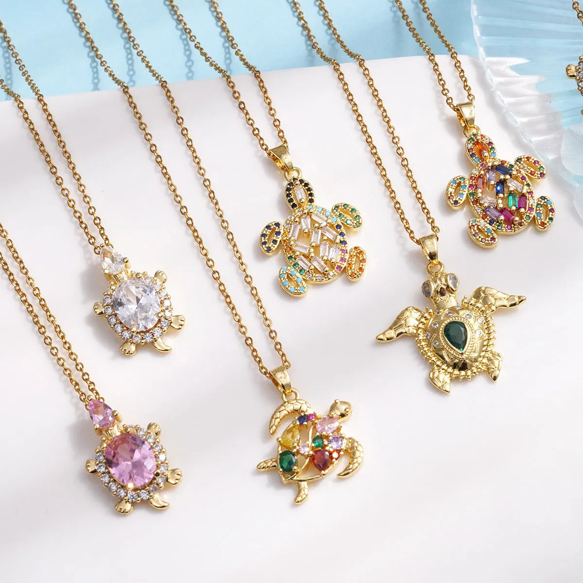 Gold-plated copper sea turtle necklace with zirconium accents and mixed gemstone inlay, O-link chain, light luxury style for women
