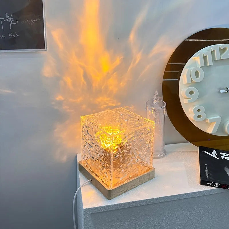 LED water ripple night light with rotating crystal projection and remote control on wooden surface