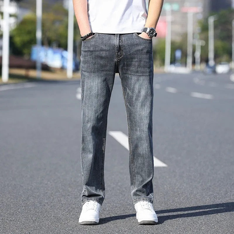 Men's thin stretch tapered denim trousers in light blue colour on a business casual model