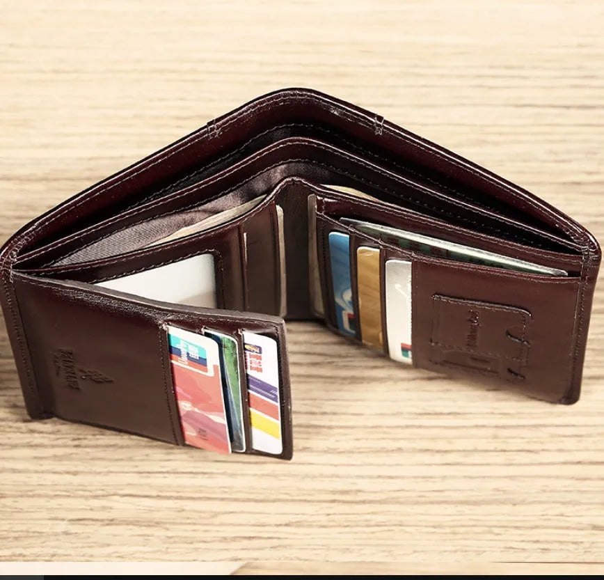 Men's black leather wallet open, showing internal card slots, photo slot, change pocket and hidden compartment.