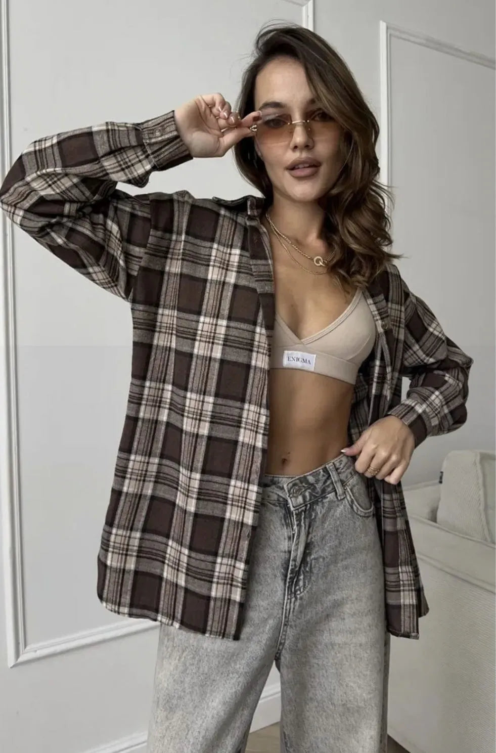 Dark brown retro striped long sleeve women's shirt on a hanger.