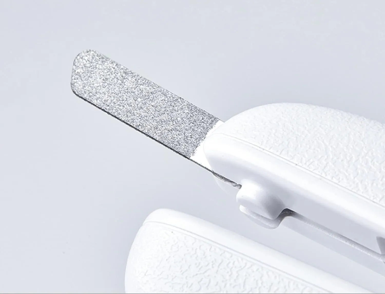 White LED pet nail clippers with a transparent guard open, showing the triangular blade and integrated nail file.