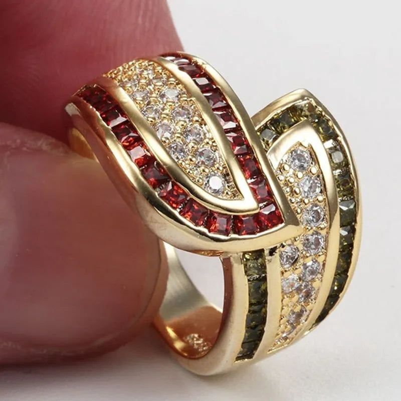 Gold tone alloy women's ring with a central peridot green stone.