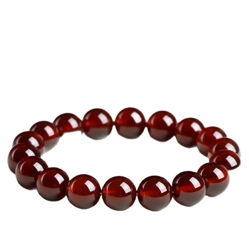 Close-up of a natural orange red garnet crystal bracelet in a unisex retro style with Ruyi design elements.