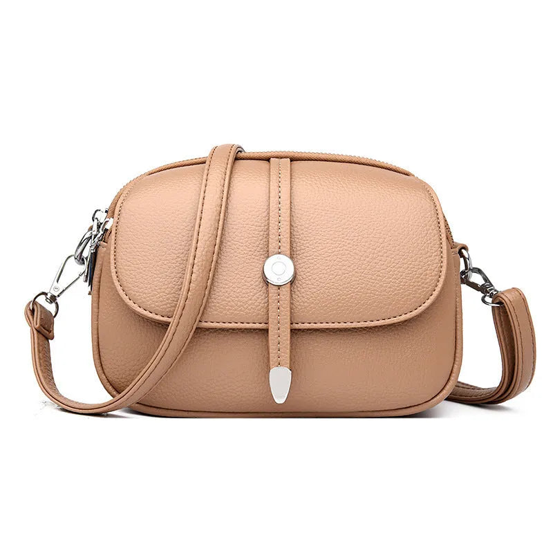 Women's soft PU leather crossbody shoulder bag in oval suitcase shape, shown in black colour with decorative sewing thread detailing.