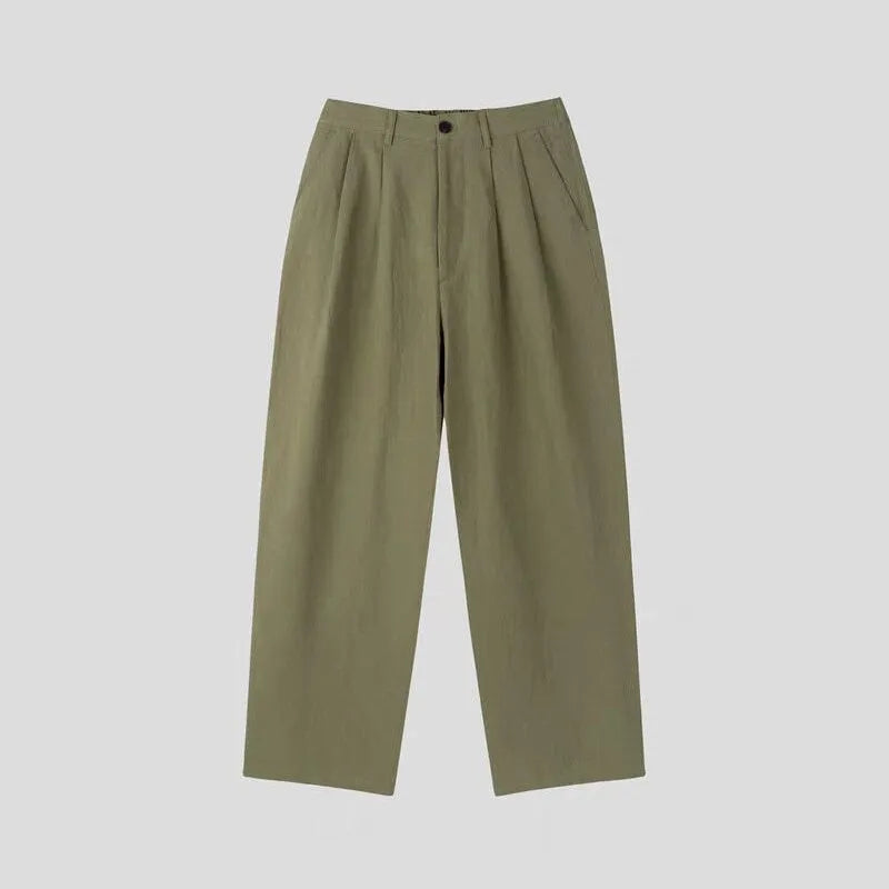 Men's loose-fit apricot cotton linen trousers with a mid-waist and pencil leg opening.