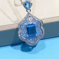 Sea blue geometric copper pendant on a plain background.