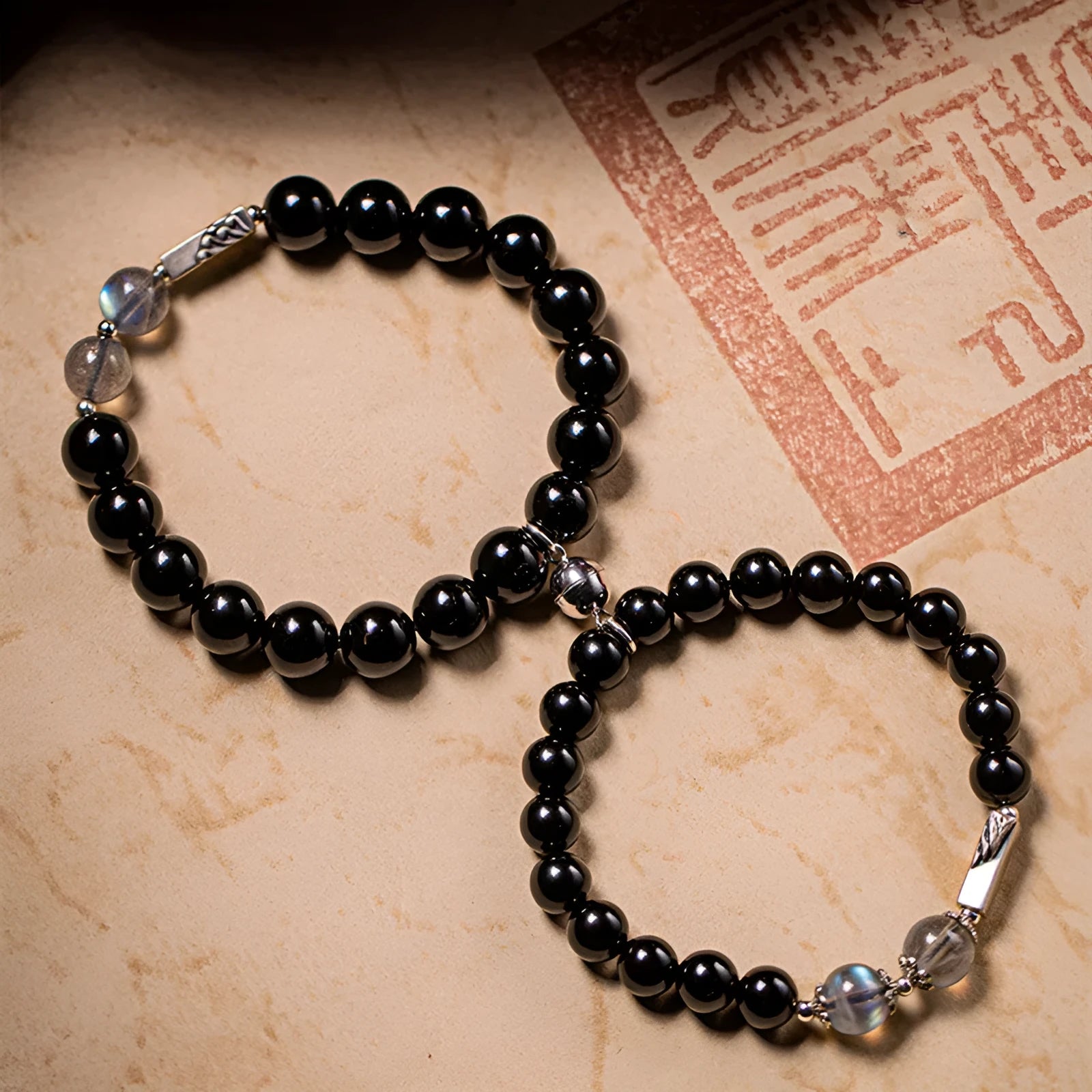 DIY kit with black obsidian Buddha beads, 8mm and 10mm sizes, and cord for a couple's bracelet set.