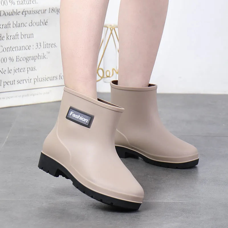 Women's mid-calf PVC rain boots in black, shown with a low heel and optional warm lining.