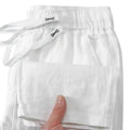 A pair of straight-leg linen trousers in a neutral colour with a visible drawstring elastic waistband.