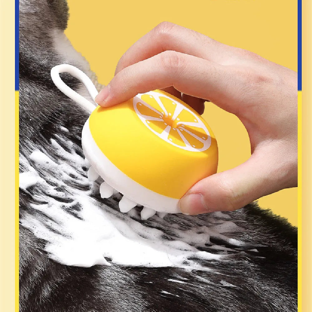 Yellow silicone pet bath brush with massage head on a blue background.