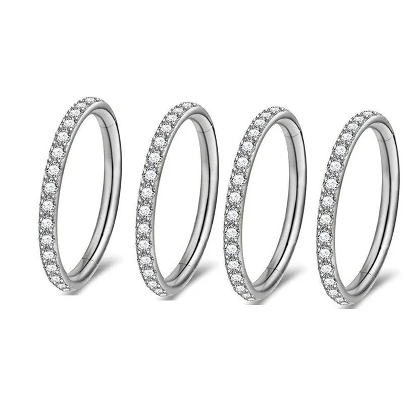 Stainless steel seamless nose ring with a small diamond on the front, shown in a gold finish.