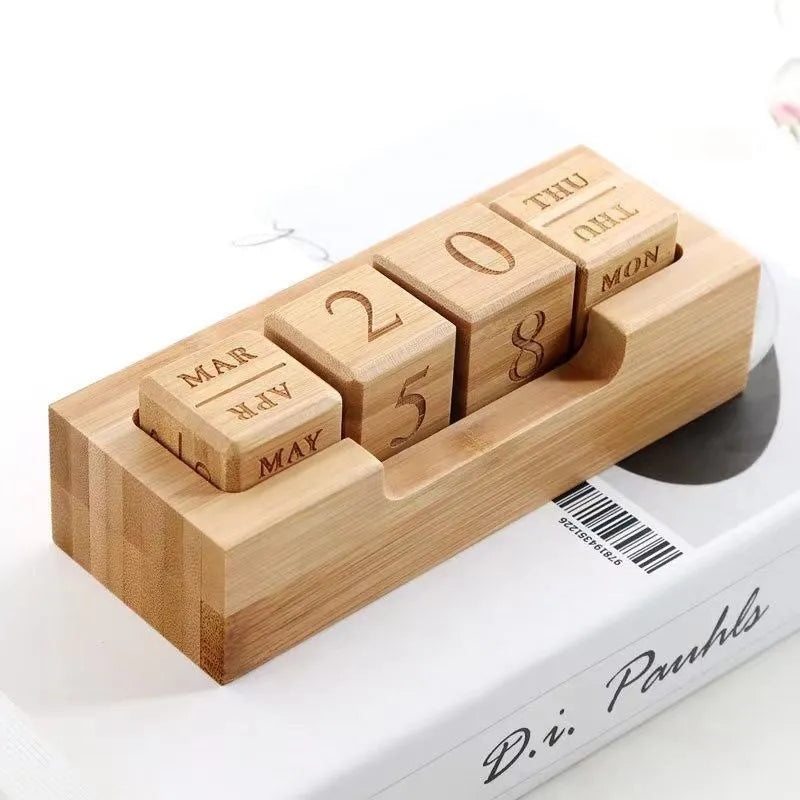 Solid wood simple modern calendar desk sign in natural wood colour on a desk.