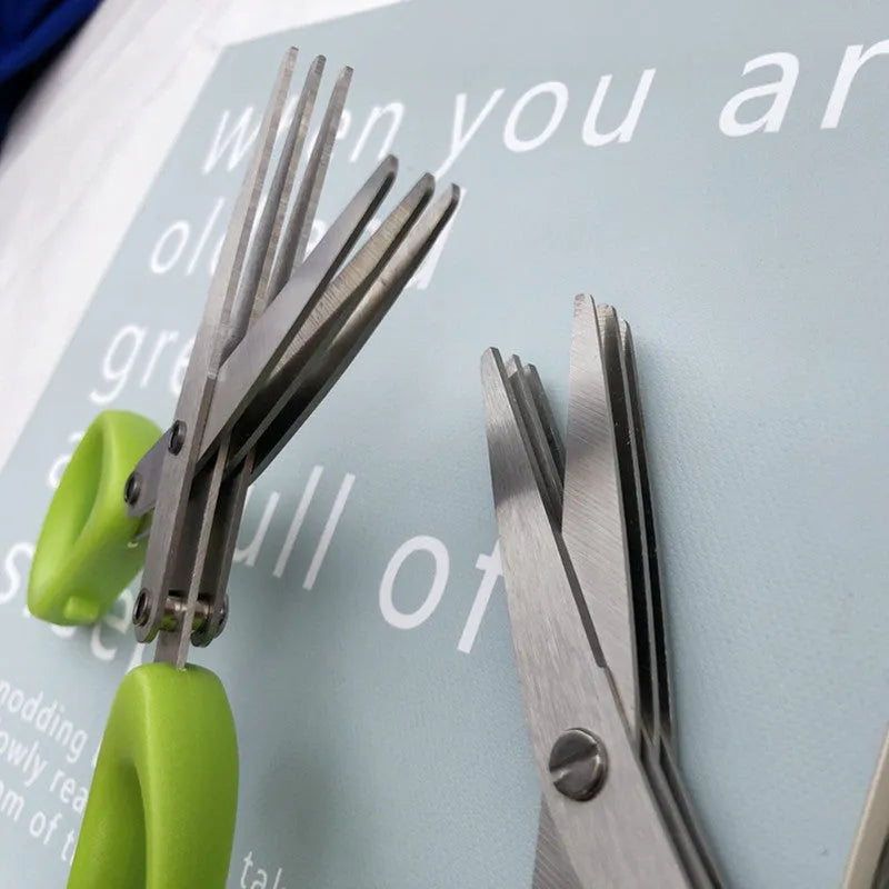 Stainless steel multi-layer herb scissors with green handles for chopping green onions and seaweed.