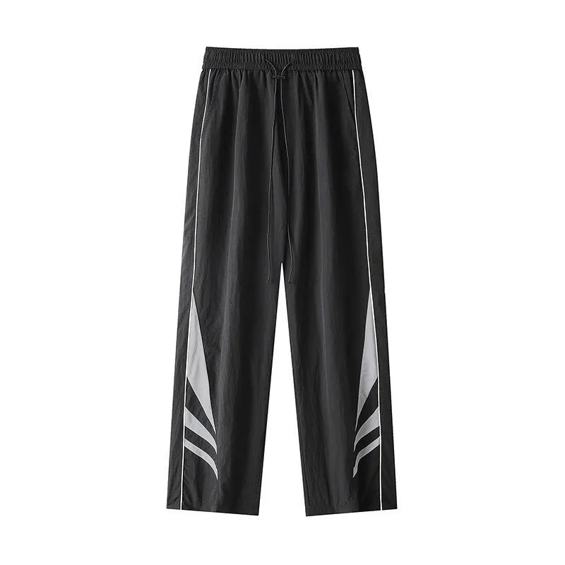 Men's loose fit straight-leg trousers in black, featuring an elasticated waist and button fly.