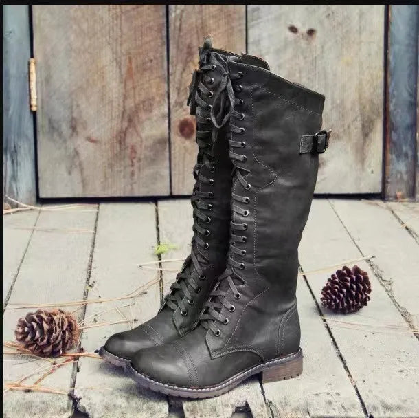 Black women's chunky heel high-leg casual boots with a round toe on a plain background.