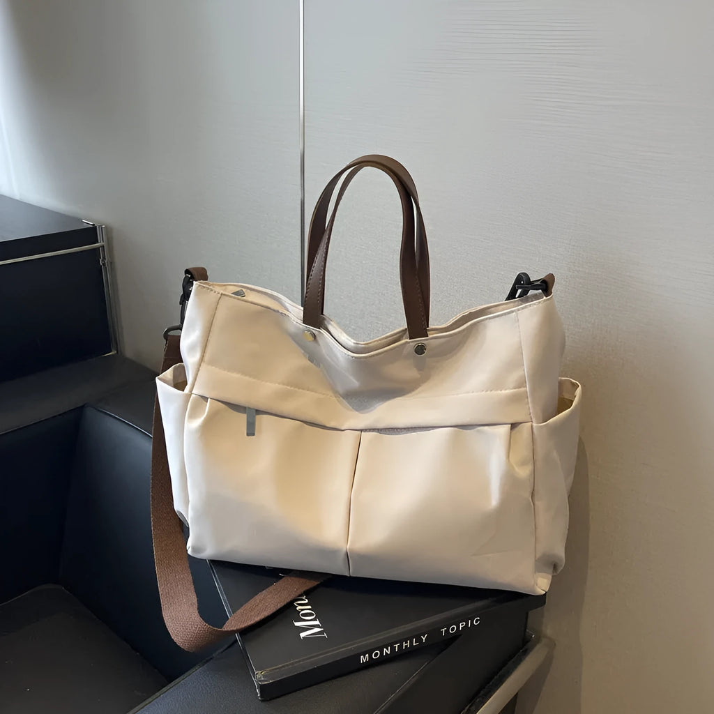Nylon crossbody bag with adjustable strap in black colour, showing tote design with 39cm length