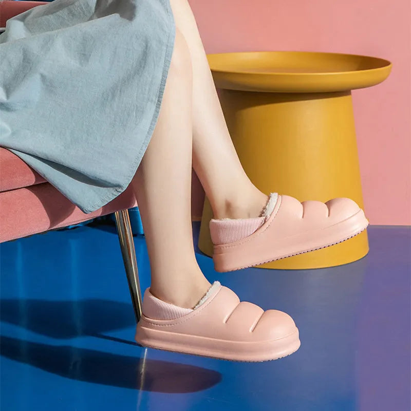 Women's waterproof EVA slippers in various colours with plush lining and a non-slip flat sole.