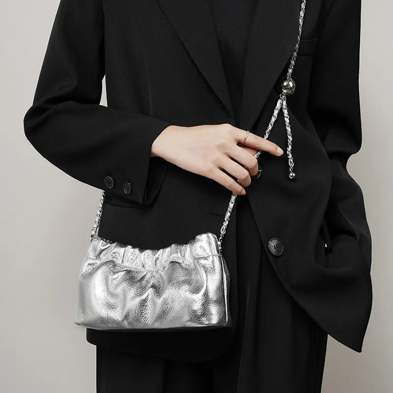Women's soft genuine leather dumpling-shaped crossbody bag in grey with a chain shoulder strap.