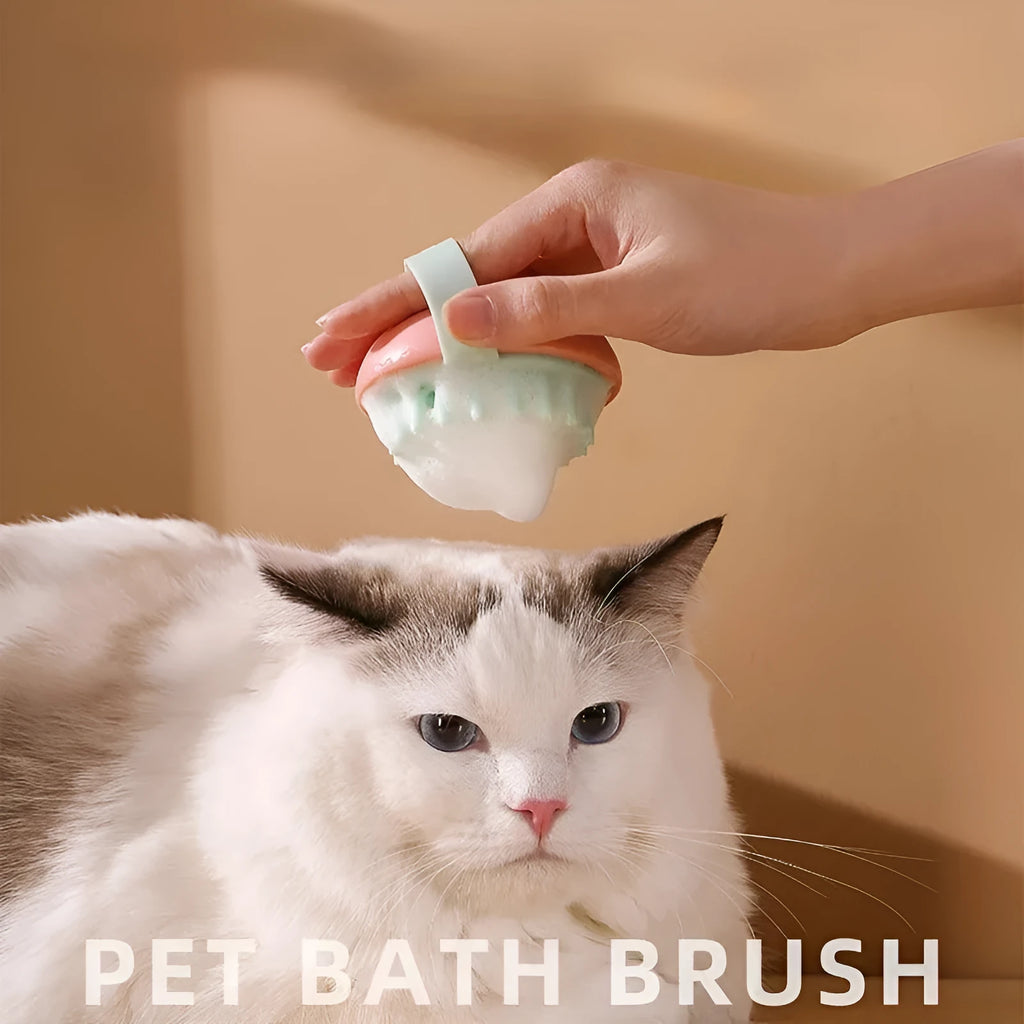 A blue silicone pet bathing brush with soft bristles and a palm-grip base for washing dogs and cats.