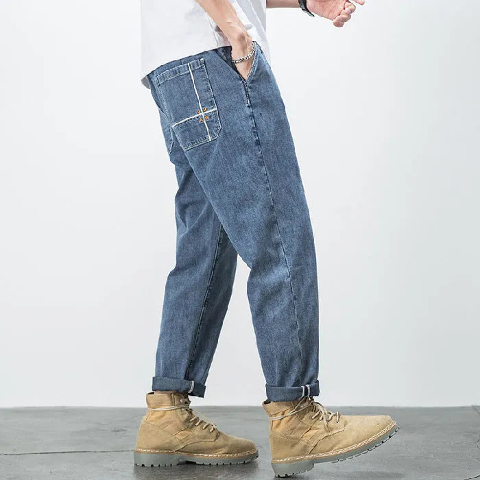 Men's loose plus size elastic waist jeans in blue cotton denim with mid waist straight leg fit