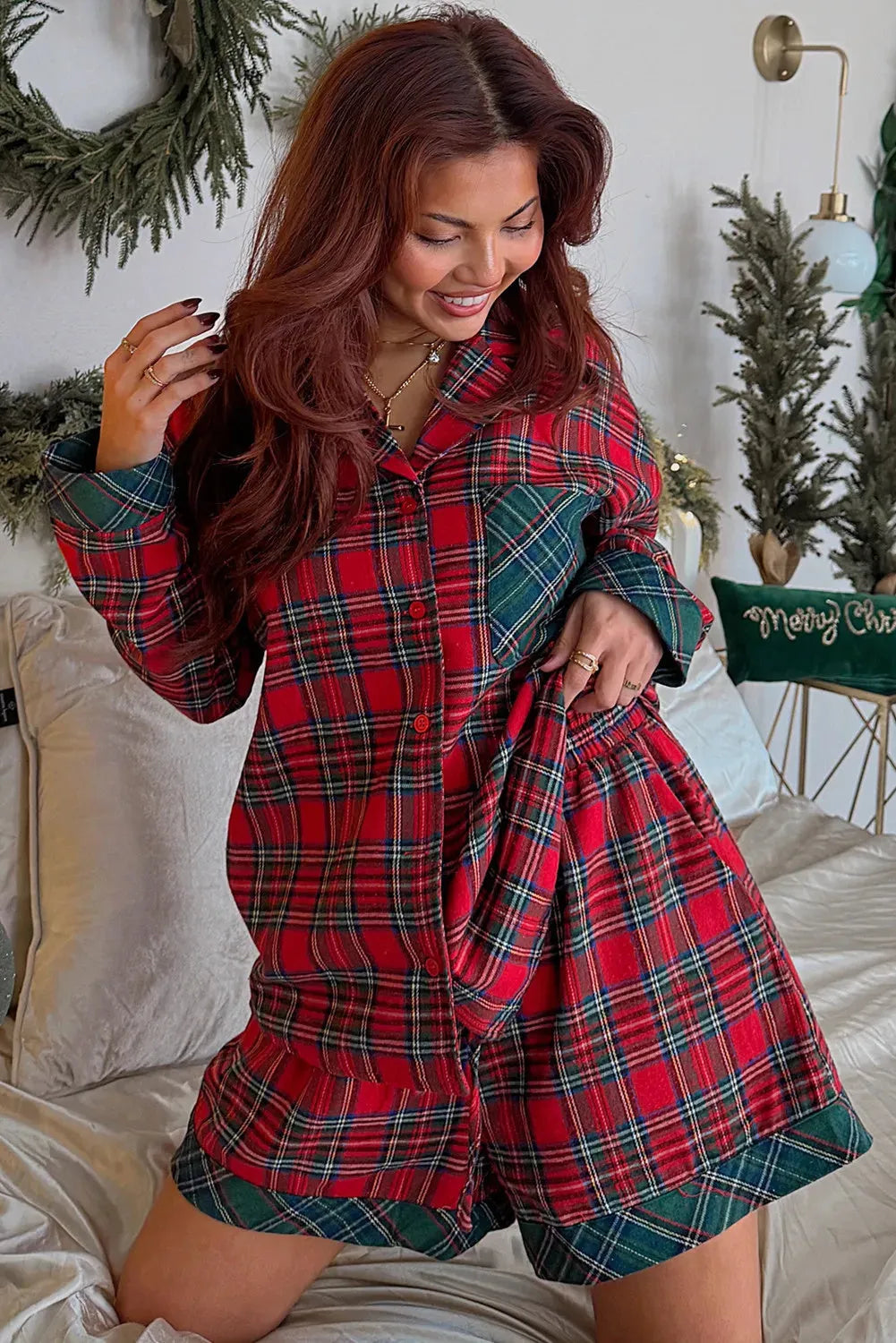 Red plaid long sleeve pyjama shirt and matching shorts set on a white background.
