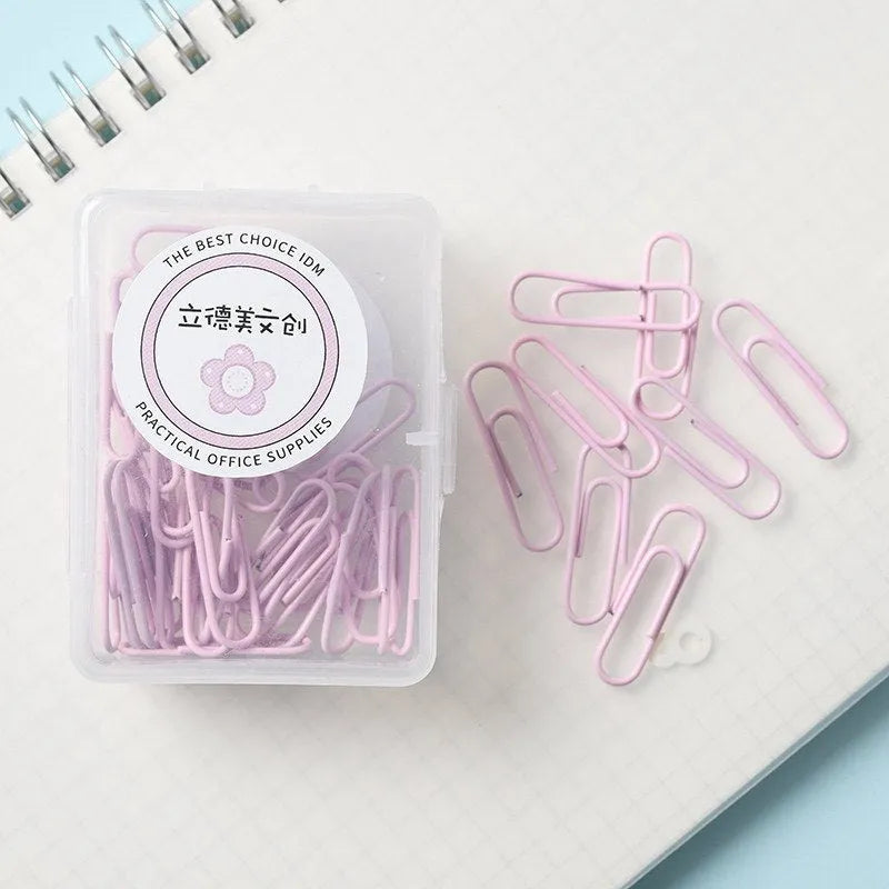 Set of macaron colour alloy paper clips in pink, green, and purple, showing 28mm and 50mm sizes, on a light background