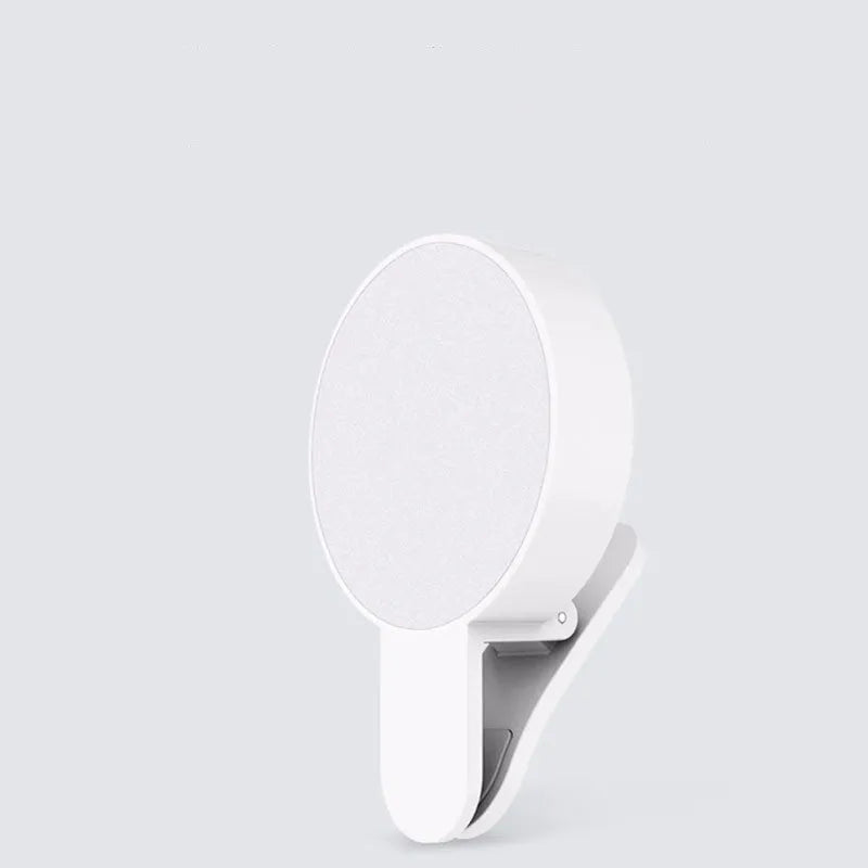 Compact white selfie fill light for mobile phones with three-level dimming switch and USB charging port.