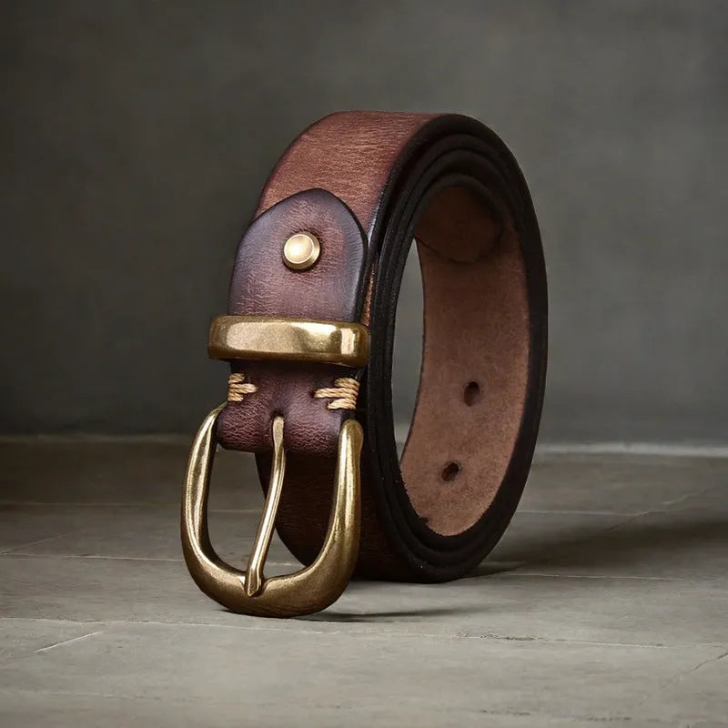 Men's brown casual leather belt with a copper pin buckle on a textured background.