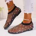 Women's flat sandals with colourful rhinestones on a breathable mesh upper and rubber sole.